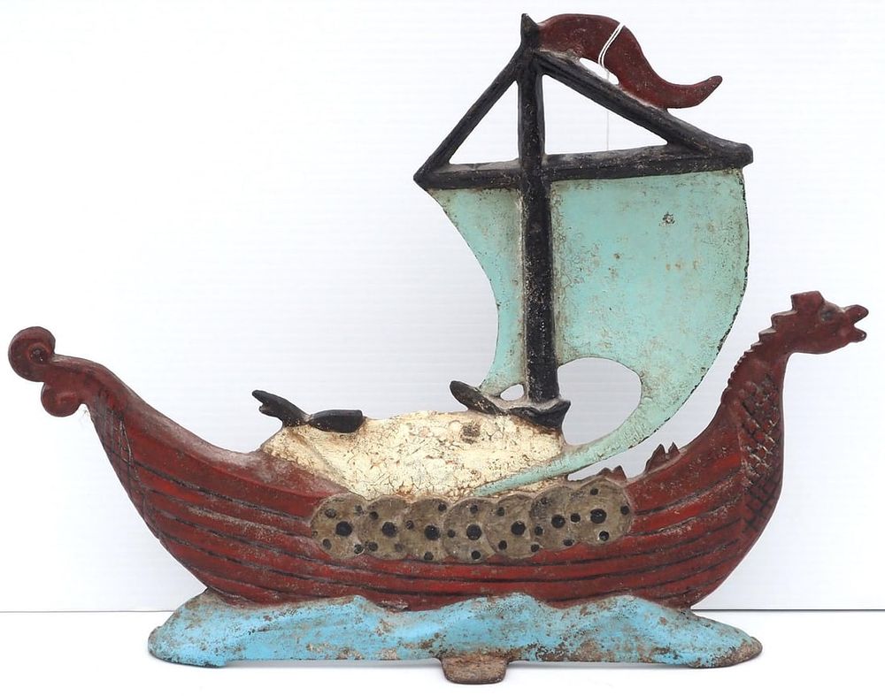 Lot 1039: Cast iron ship-shaped door stop