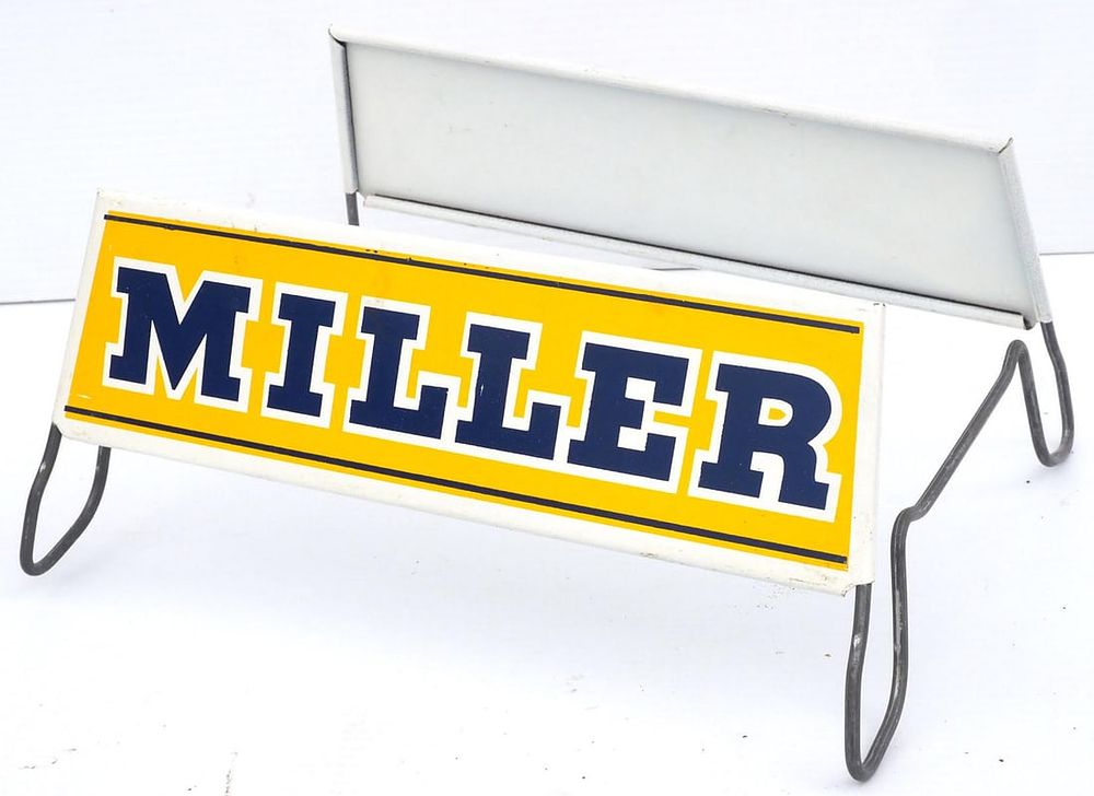 Lot 1245: Miller metal tire holder with tin sign