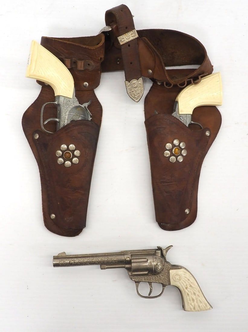 Lot 298: (3) Cap guns and a holster