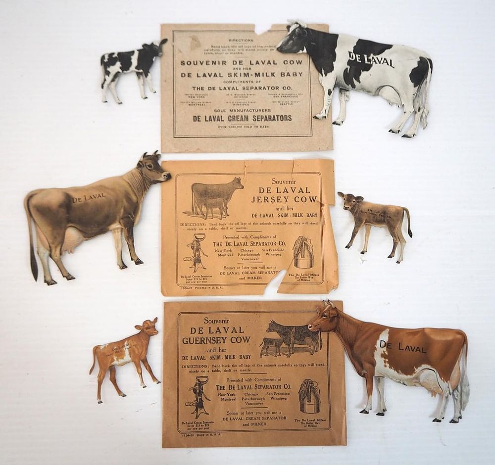 Lot 1005: (3) Tin die-cut DeLaval advertising cow & calf sets
