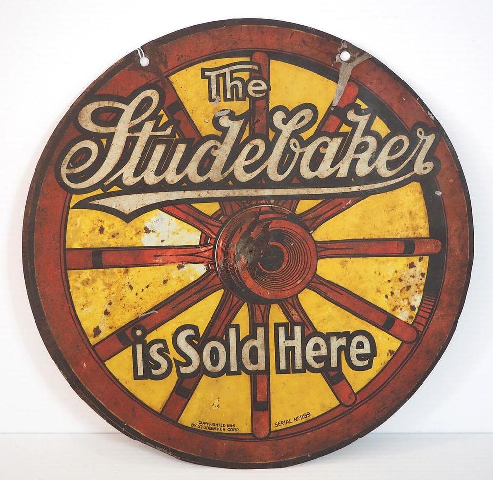 Lot 1204: The Studebaker Sold Here wagon wheel-shaped sign