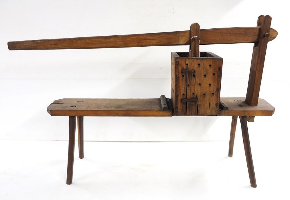 Lot 59: Primitive wooden fruit press on bench