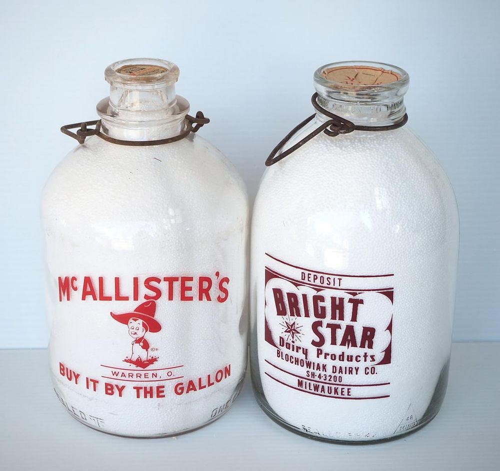 Lot 693: (2) 1 gallon milk bottles