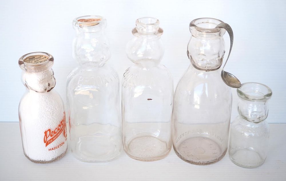 Lot 742: (5) Baby face milk bottles