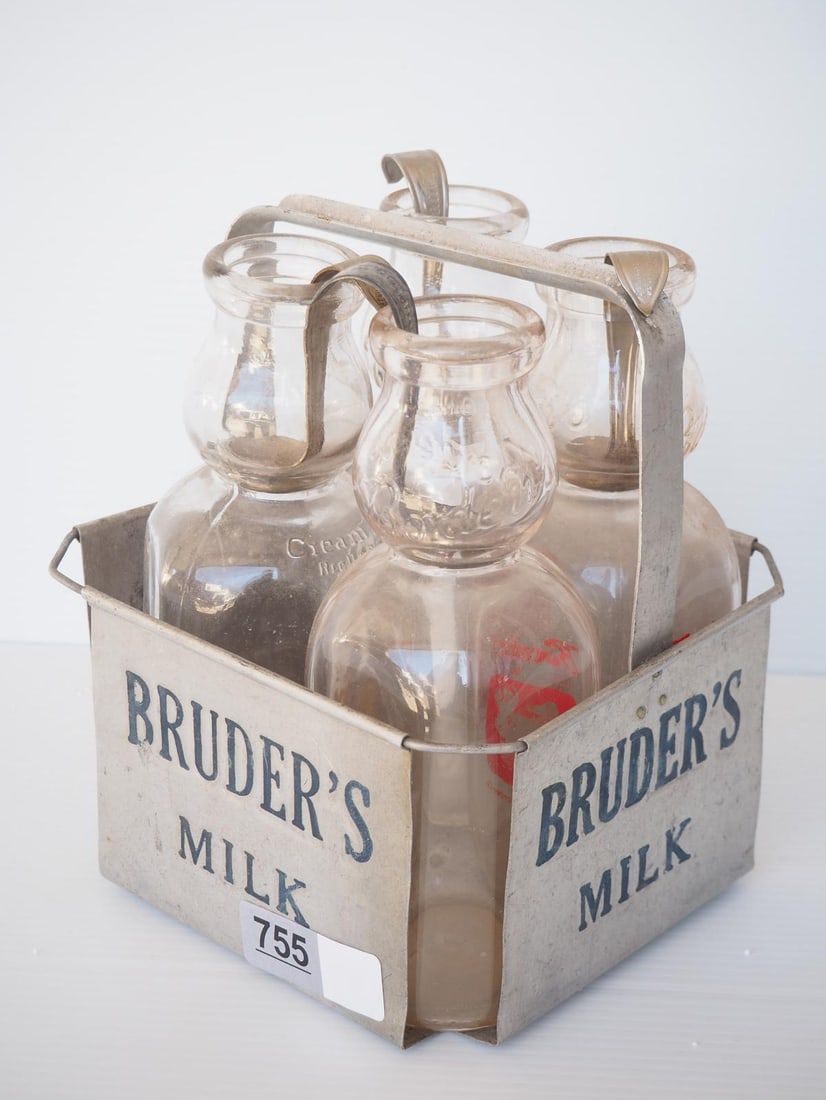 Lot 755: (4) 1 quart cream top milk bottles in carrier