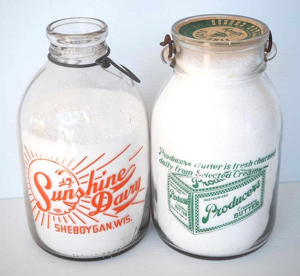 Lot 780: (2) 1 gallon milk bottles