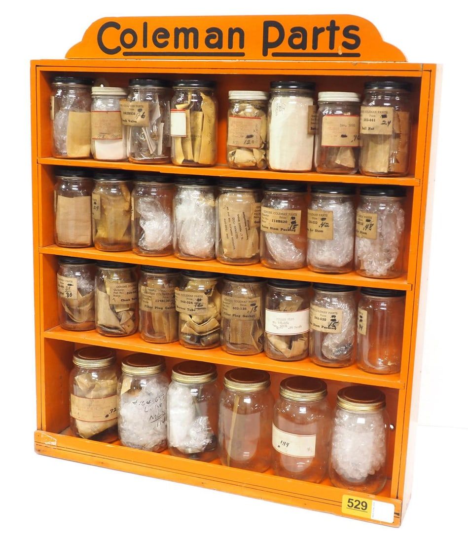 Lot 529: 4-shelf Coleman parts rack with Coleman parts