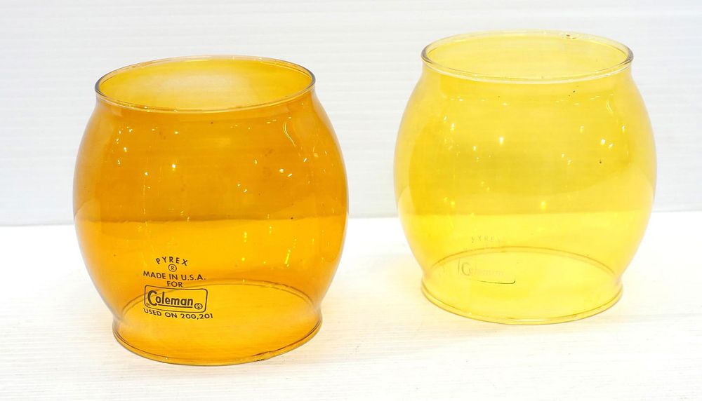 Lot 555: (2) Coleman amber globes