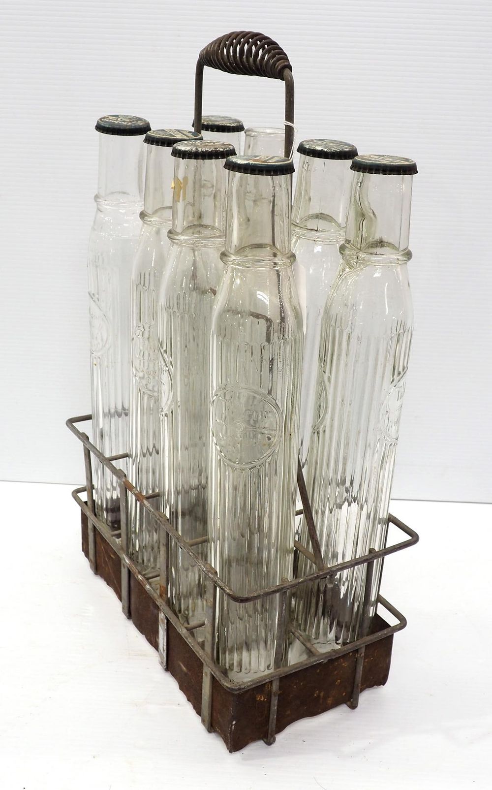 Lot 1216: Tiolene oil bottles with wire carrier