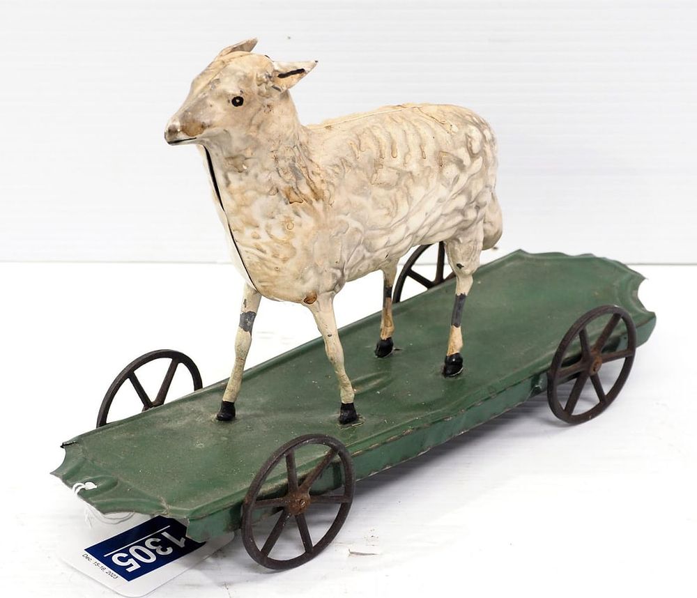 Lot 1305: Early tin sheep-shaped child's pull toy