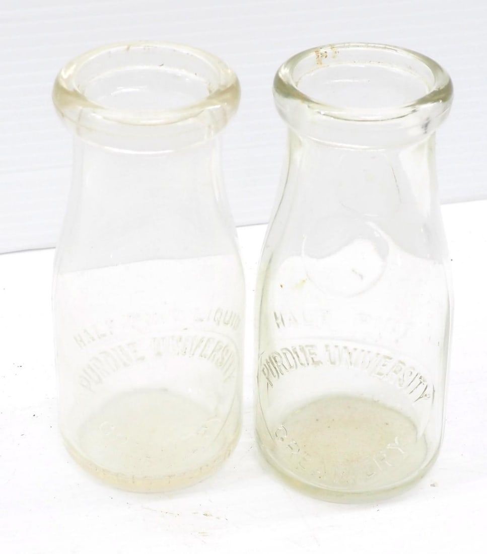 Lot 7: (2) glass milk bottles