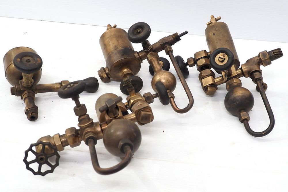Lot 350: (4) Brass steam engine oilers