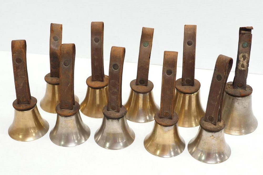 Lot 1089: (10) Brass bells with leather straps