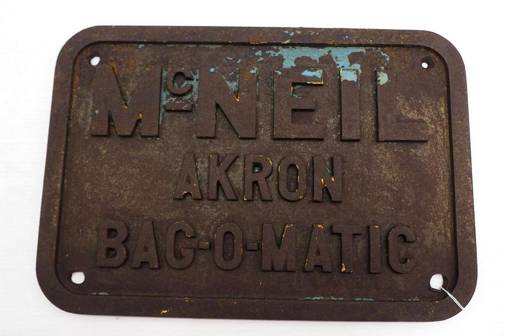 Lot 1140: Cast iron McNeil Akron Bag-O-Matic sign