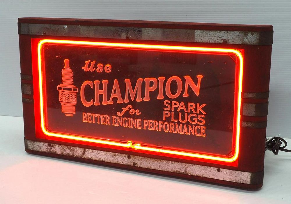 Lot 1202: Neon lighted Champion Spark Plugs sign