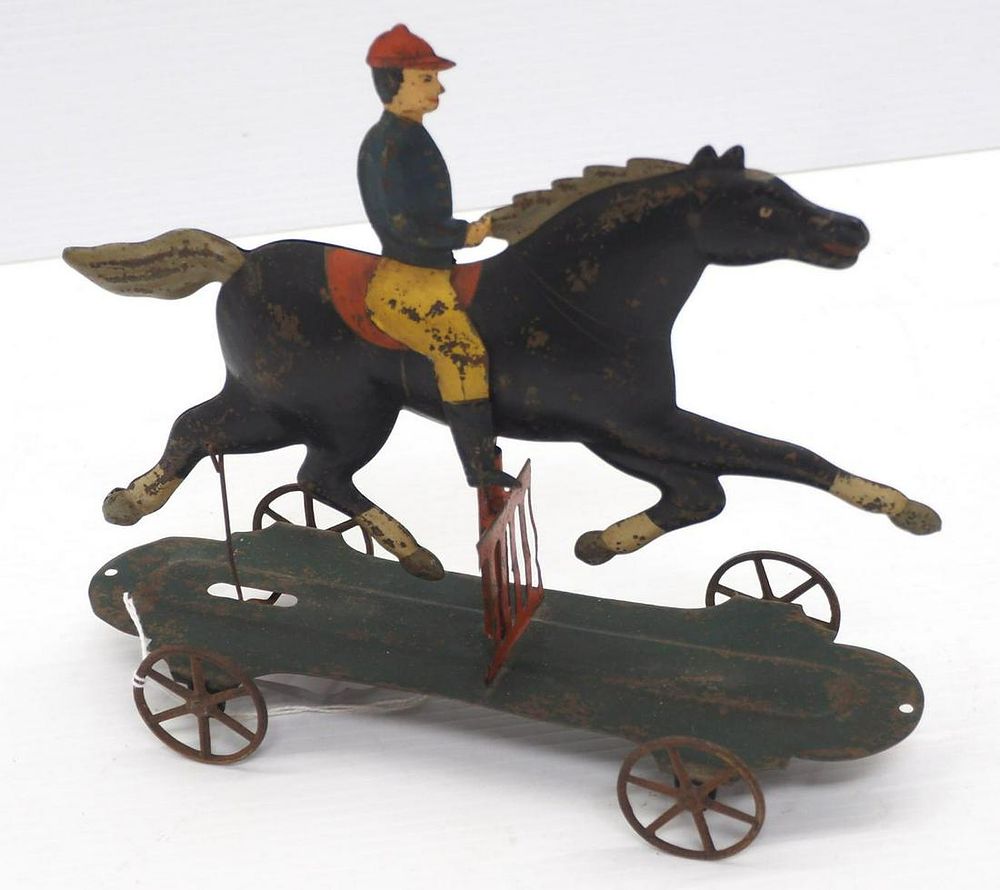 Lot 1275: Tin rocking horse & rider toy