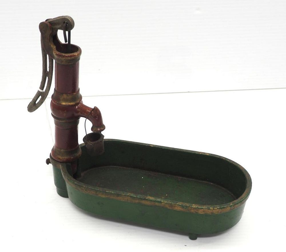 Lot 290: Cast iron miniature hand water pump with tank