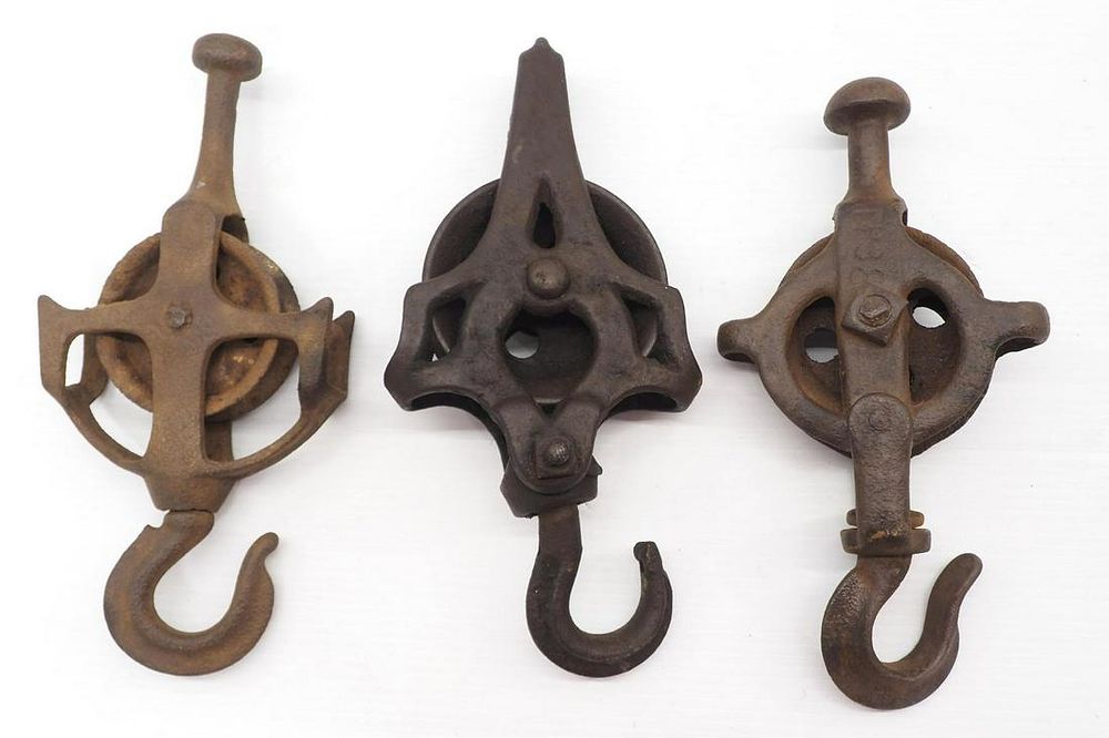 Lot 629: (3) Different cast iron drop pulleys
