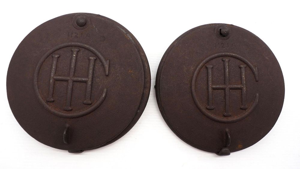 Lot 851: (2) IHC cast iron planter lids