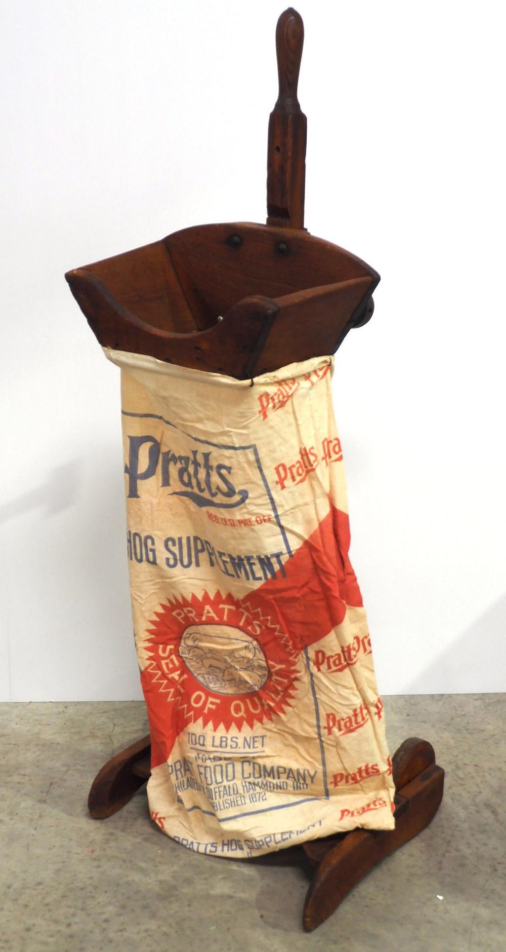 Lot 899: Very primitive feed bagger with wooden wheels