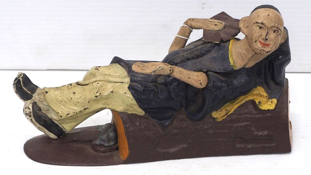 Lot 1690: "Reclining Chinaman" mechanical bank