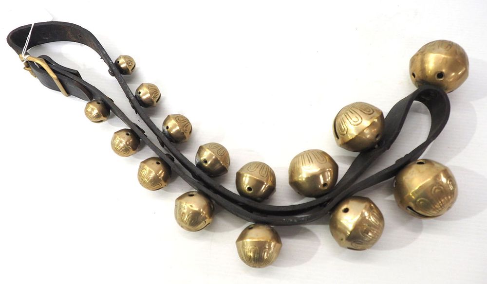 Lot 563: Strap of 15 brass sleigh bells up to size 15
