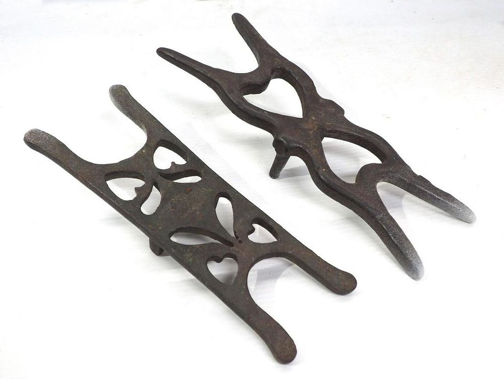 Lot 853: (2) Early cast iron boot jacks