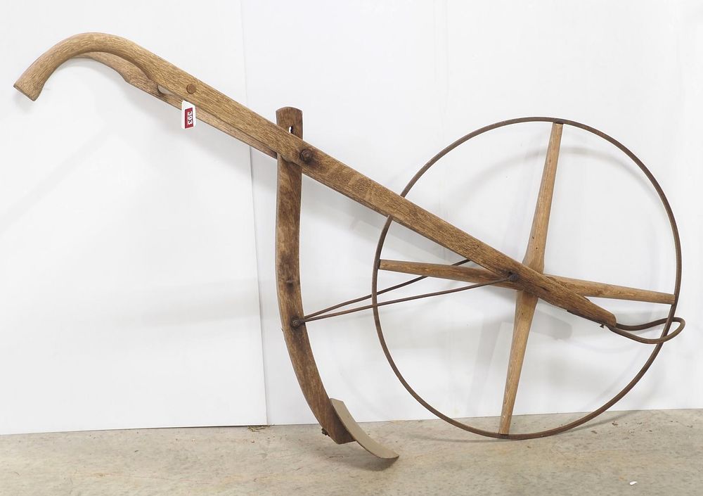 Lot 393: Wood-handle push-type plow with metal rim