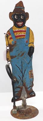 Metal boy-shaped lawn sprinkler with hose attachment, 30"H, base is 8"dia. - Fair with rust