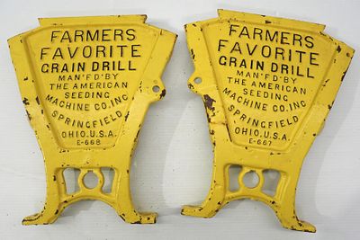 Pair of cast iron planter box ends. Pair of cast iron Farmers Favorite Grain Drill planter box ends