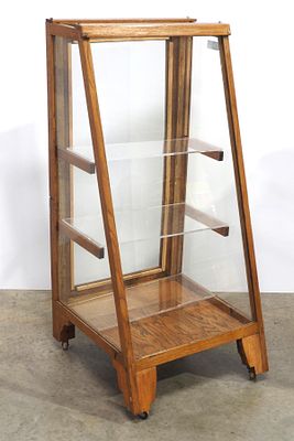 Floor model slant-front country store display case with glass shelves and swinging back door 