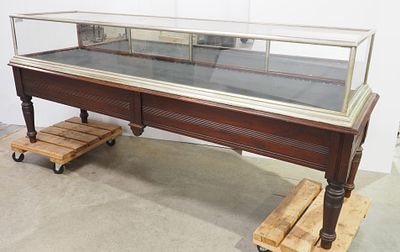 8.5-foot long country store display case with nickel plating and fold-down mirrored back doors 