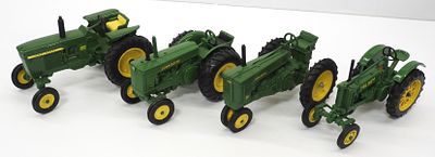 (4) Ertl John Deere tractors. (4) 1/16 scale Ertl John Deere tractors: GP, 70, AR, and 3010 
