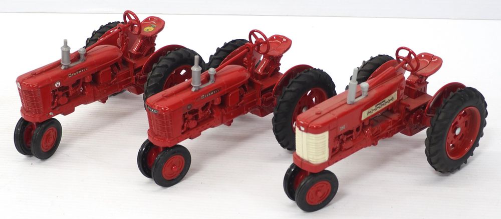 Lot 209: (3) Ertl Farmall tractors
