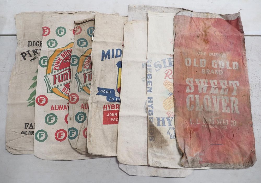 Lot 681: (8) Cloth seed bags with colorful graphics