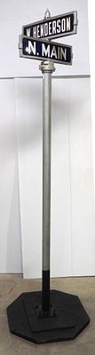 Municipal sign post with porcelain street signs for N. Main and W. Henderson, 88"H with stand * 