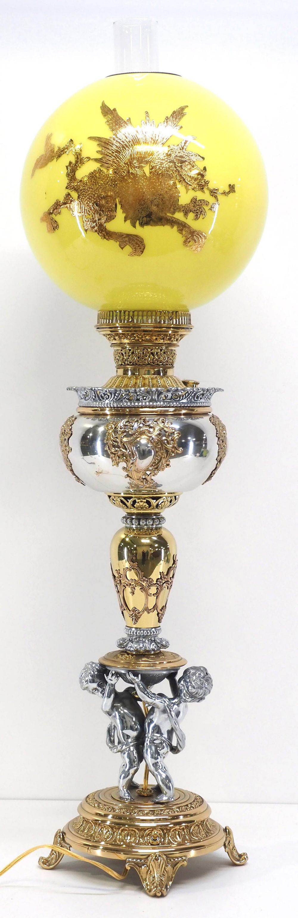 Lot 182: Victorian Banquet Lamp with Cherubs and Yellow Cased Ball Globe