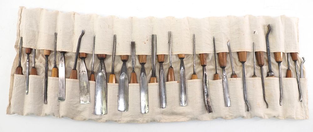 Lot 182: (32) Wood handled chisels in cloth holder