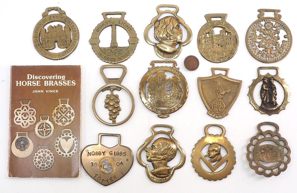 Lot 205: (13) Brass harness ornaments with book