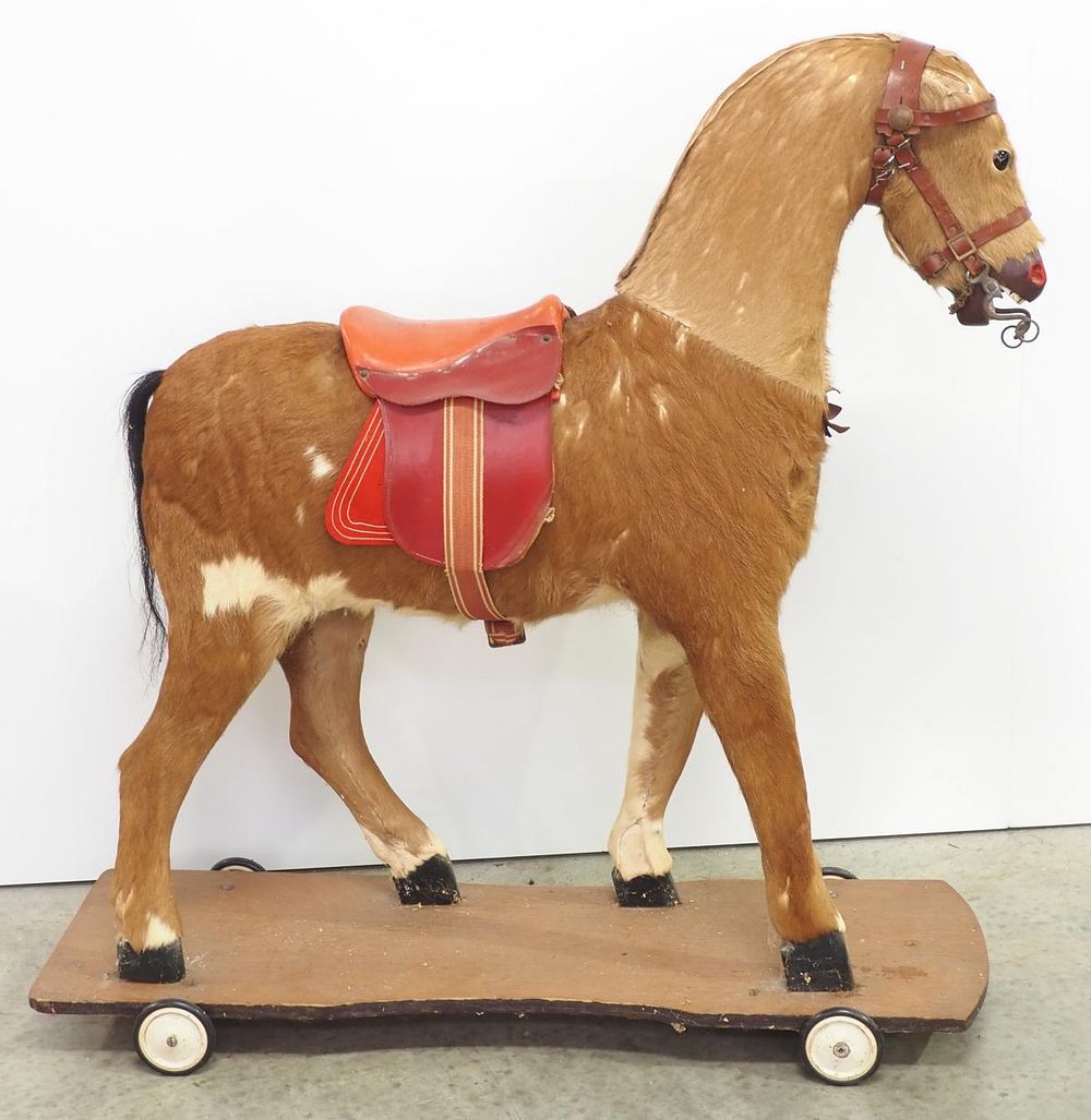 Lot 364: Early child's riding horse on wheels