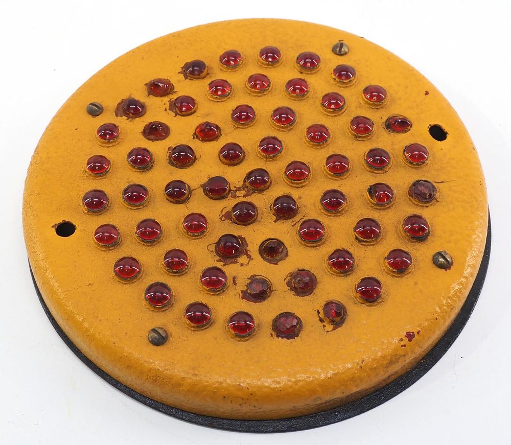 Lot 432: Road sign reflector with red glass 'cat-eye' marbles