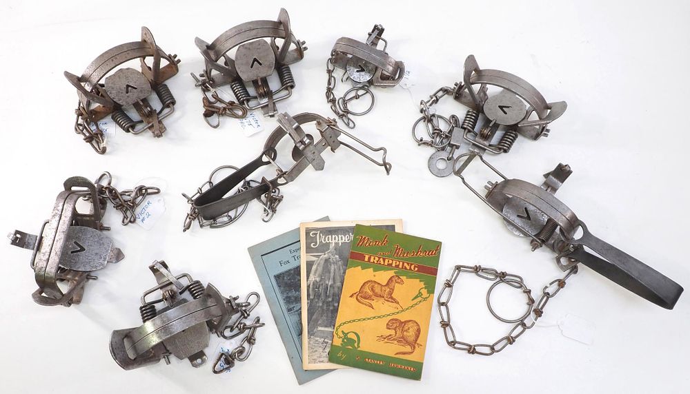 Lot 621: (8) Victor traps and (3) Trapping Guide pamphlets