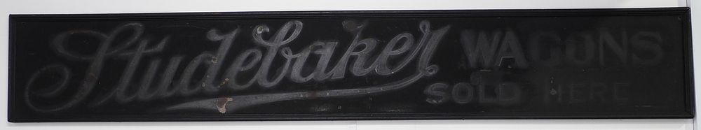 Lot 324: Studebaker Wagons Sold Here sign