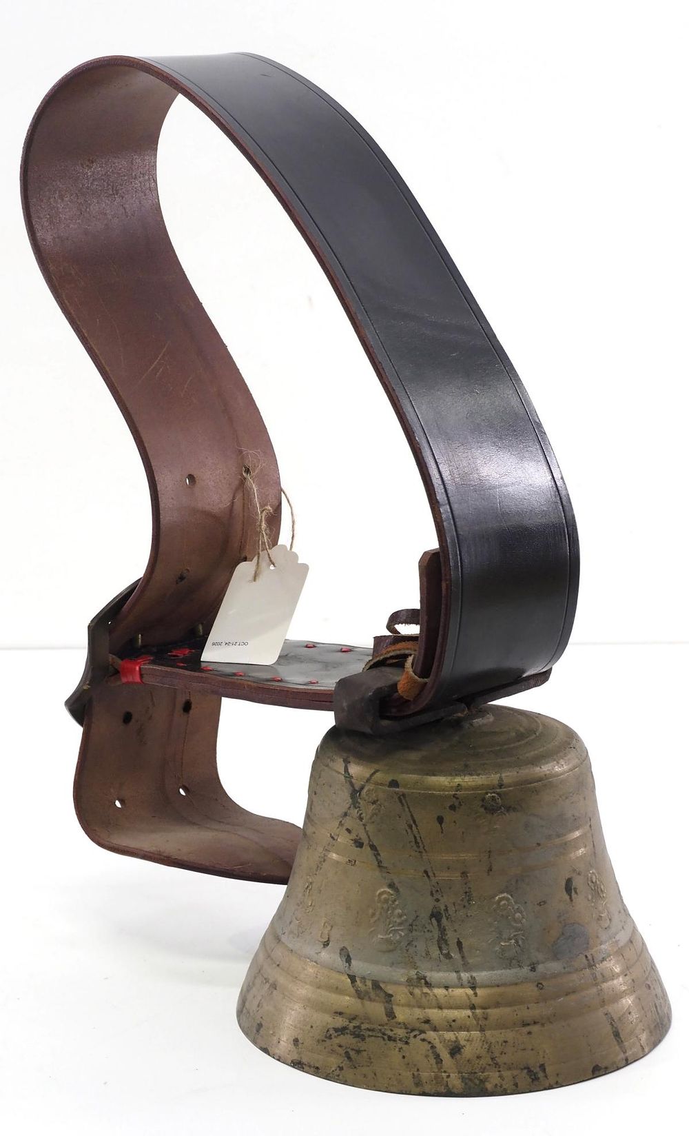 Lot 387: Brass cowbell on wide leather strap