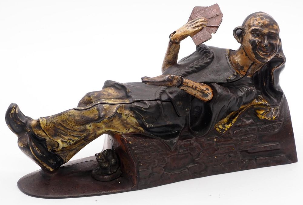 Lot 1045: "Reclining Chinaman" mechanical bank