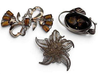 Three Sterling Silver Brooches, 51.0g total weight. Amber brooch marked "925." Approximately 