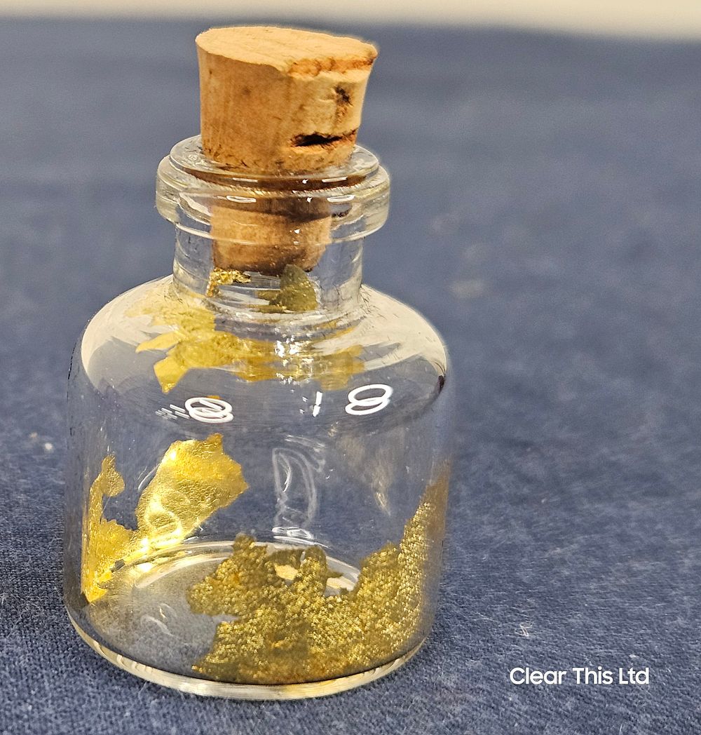 Lot 99: Small Corked Glass Bottle With Gold Leaf inside.