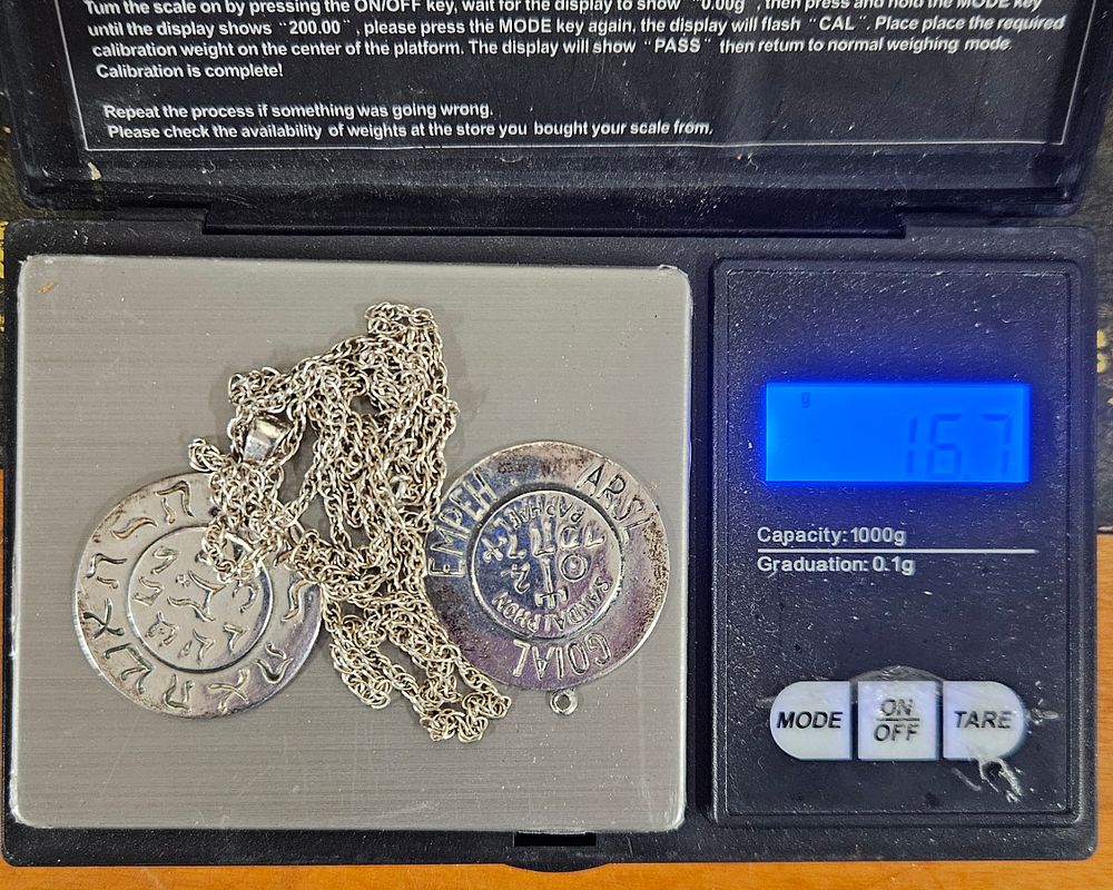 Lot 100: Two Sterling Silver Pendants. One with Chain