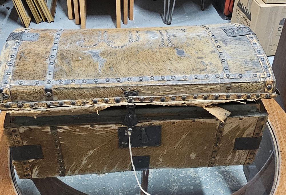 Lot 312: Small animal hide covered trunk. 22 inches wide 11 tall and 12 deep.