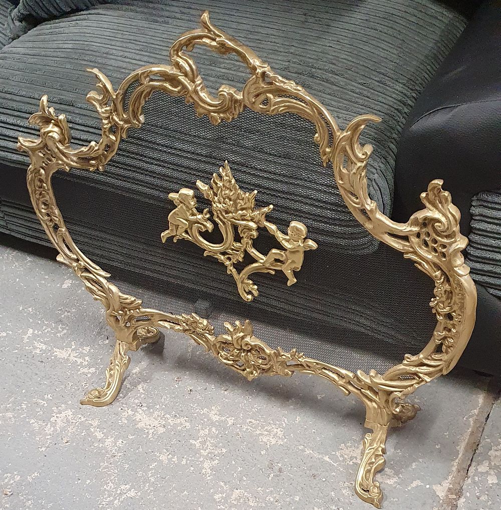 Lot 253: Antique brass cherub free standing fire screen